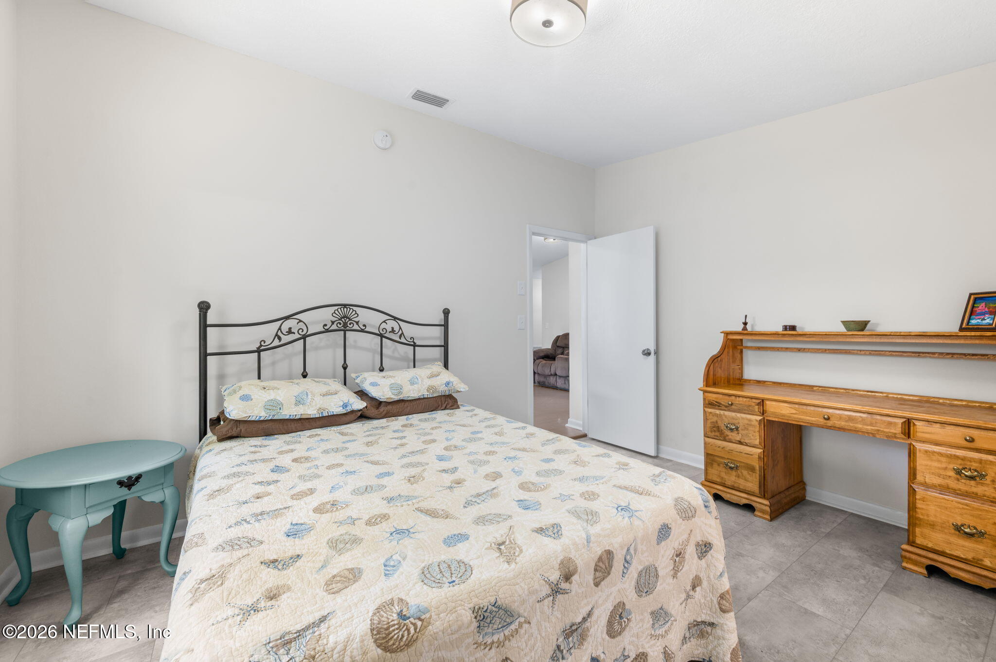 507 Gentian Road St. Augustine, FL 32086 - Photo 31 of 82 a bedroom with a bed and a chair