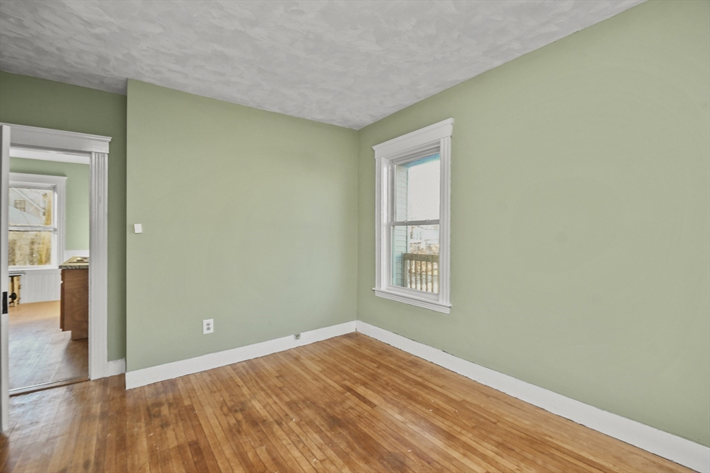 23 Ashton Street Worcester, MA 01605 - Photo 14 of 41 an empty room with wooden floor and windows