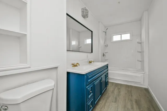 a bathroom with a sink a toilet and mirror
