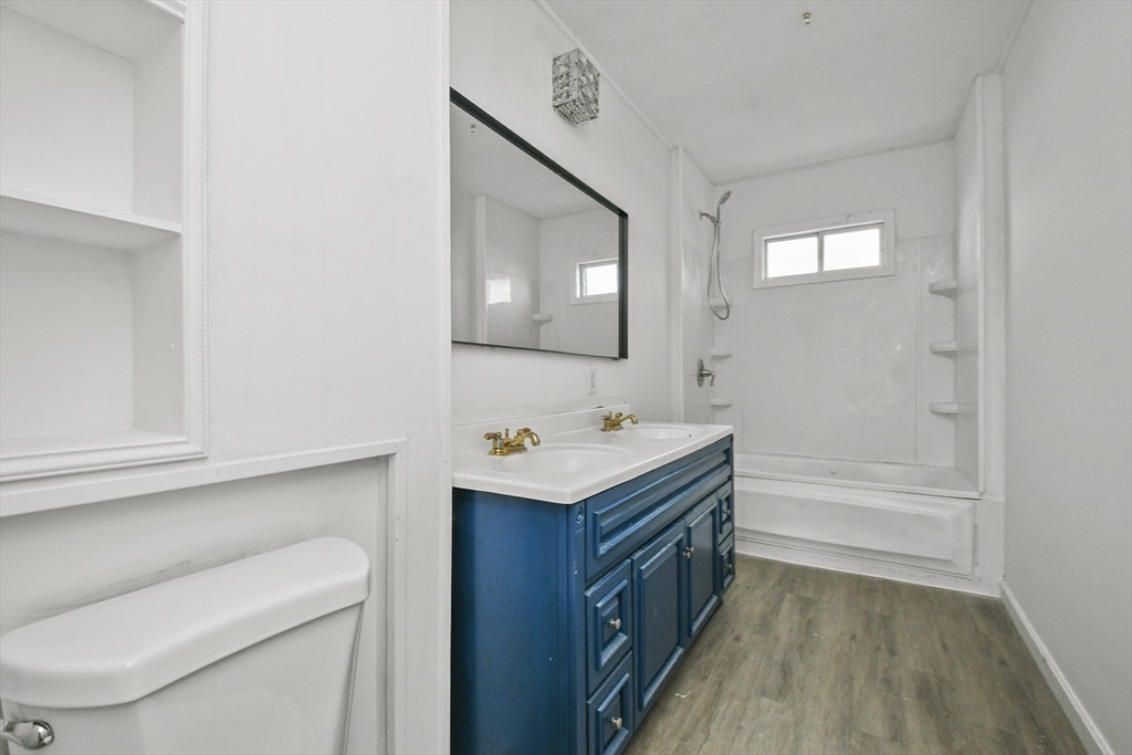 23 Ashton Street Worcester, MA 01605 - Photo 15 of 41 a bathroom with a sink a toilet and mirror