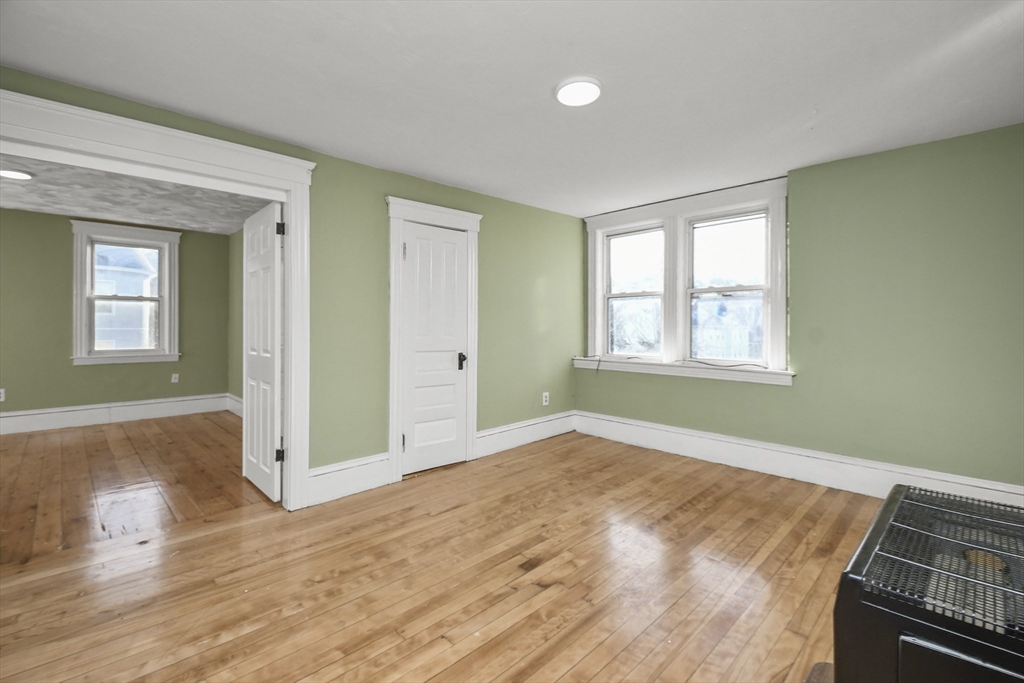 23 Ashton Street Worcester, MA 01605 - Photo 22 of 41 a view of an empty room with wooden floor and a window