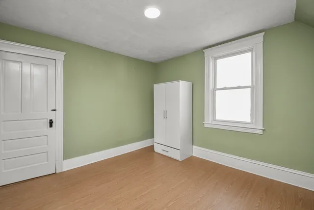 an empty room with windows and closet
