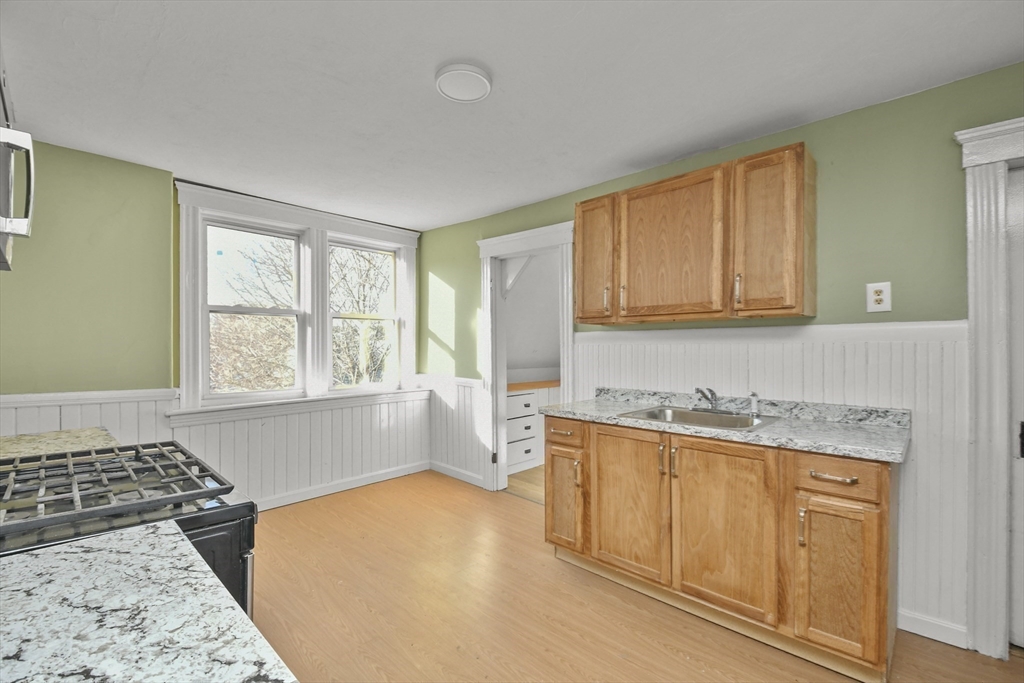 23 Ashton Street Worcester, MA 01605 - Photo 27 of 41 a kitchen with a stove a sink and a cabinets