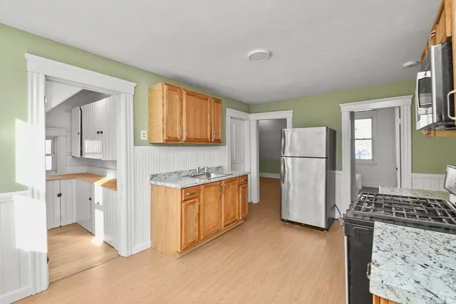 a kitchen with a refrigerator a stove top oven a refrigerator and a window