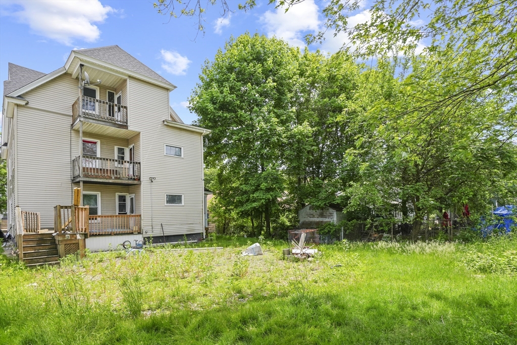 23 Ashton Street Worcester, MA 01605 - Photo 39 of 41 a backyard of a house with lots of green space