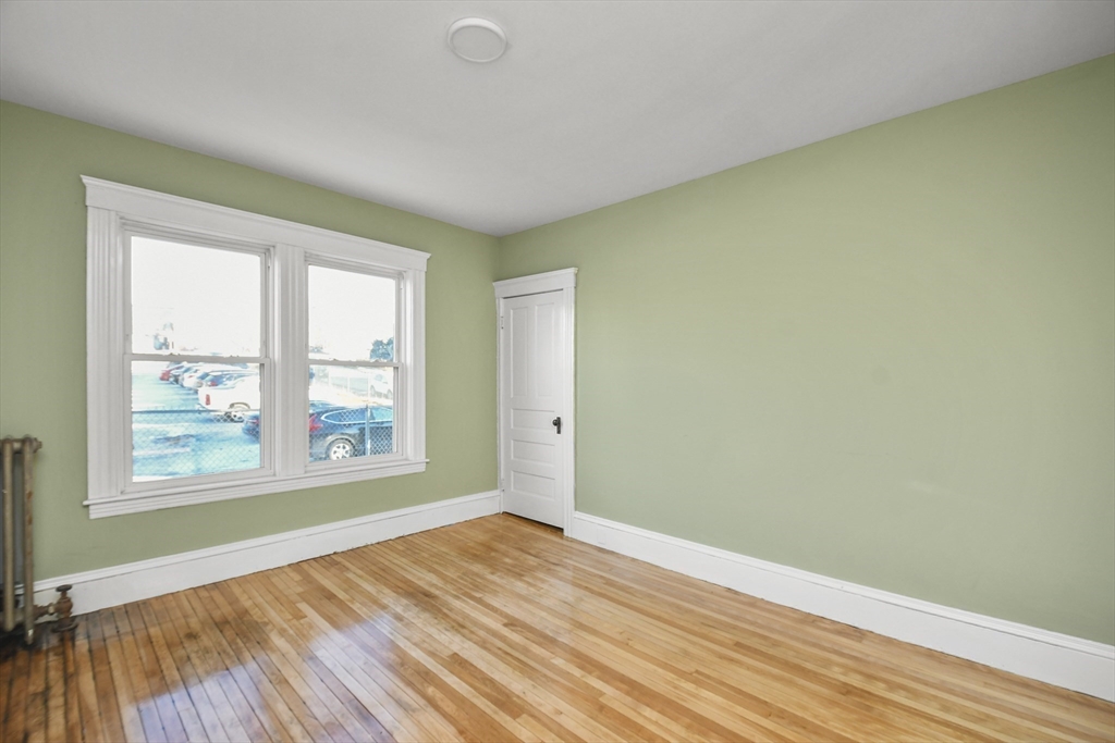 23 Ashton Street Worcester, MA 01605 - Photo 7 of 41 an empty room with wooden floor and windows