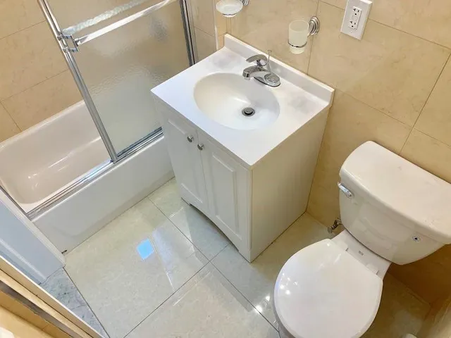 a bathroom with a sink a toilet and mirror