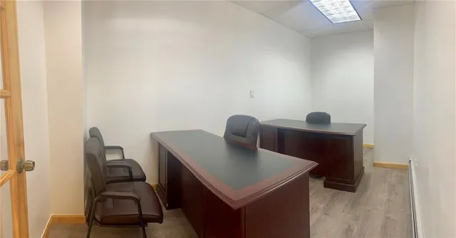 a view of a workspace with furniture