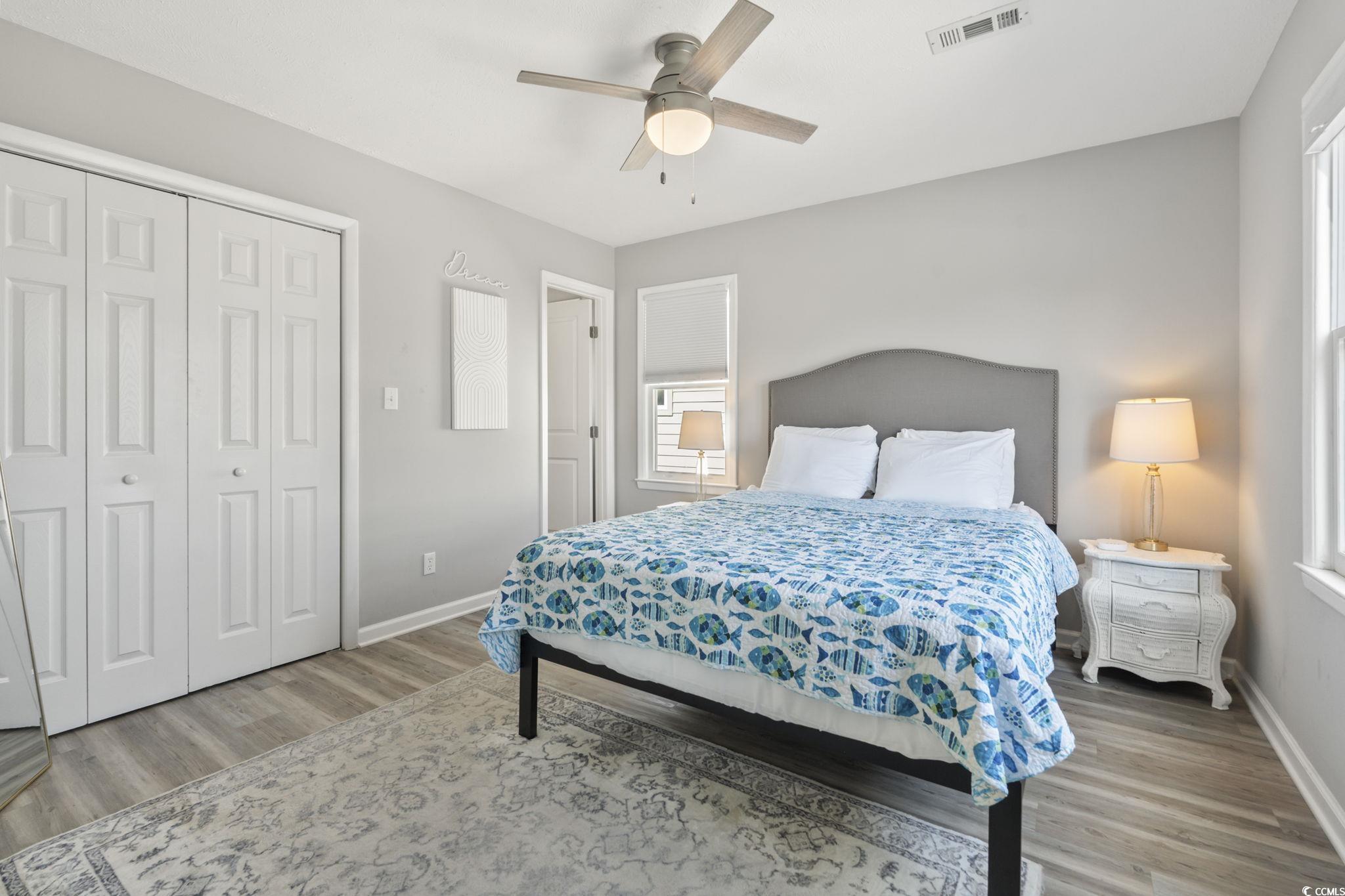3182 State Rd S-26-816 Murrells Inlet, SC 29576 - Photo 10 of 40 Bedroom with a ceiling fan, light wood finished floors, and a closet