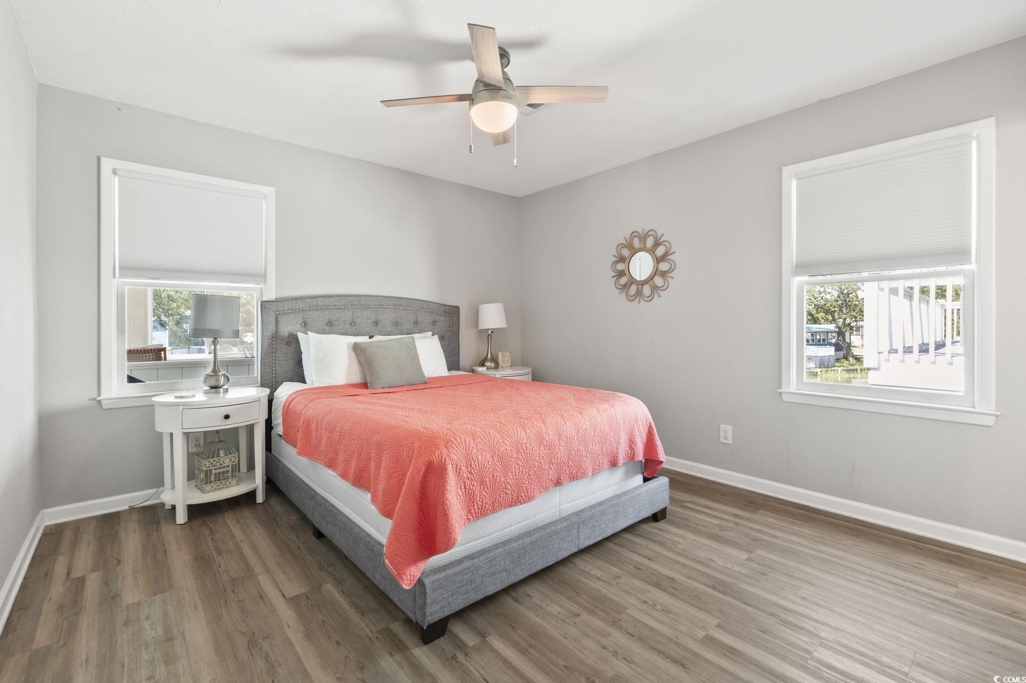 3182 State Rd S-26-816 Murrells Inlet, SC 29576 - Photo 11 of 40 Bedroom featuring multiple windows, wood finished floors, and ceiling fan
