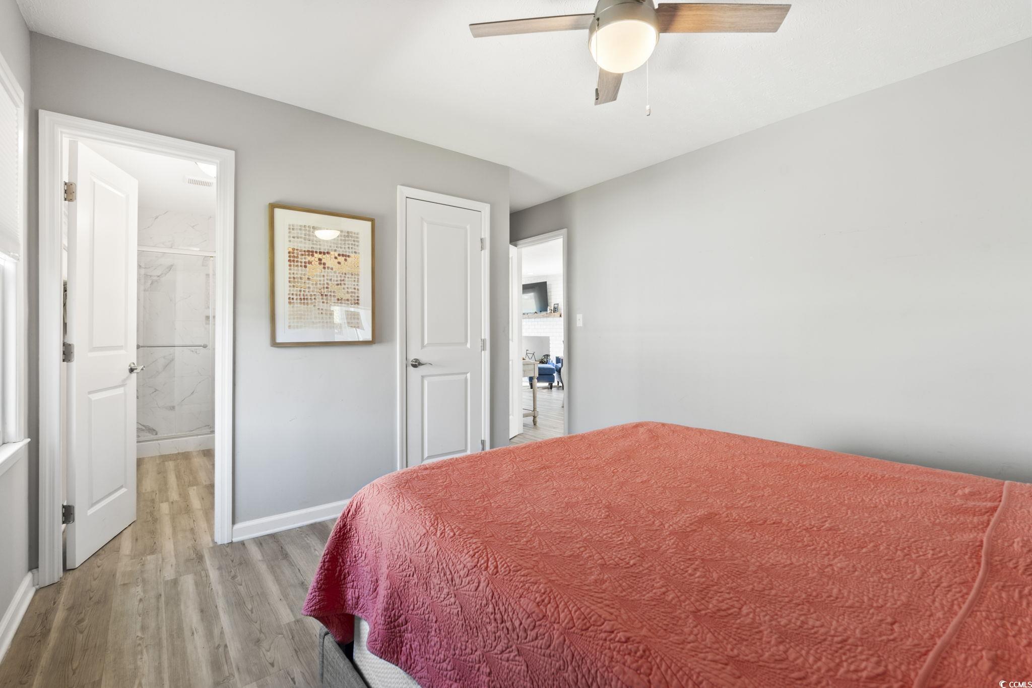 3182 State Rd S-26-816 Murrells Inlet, SC 29576 - Photo 12 of 40 Bedroom featuring light wood-style flooring, ceiling fan, and ensuite bathroom