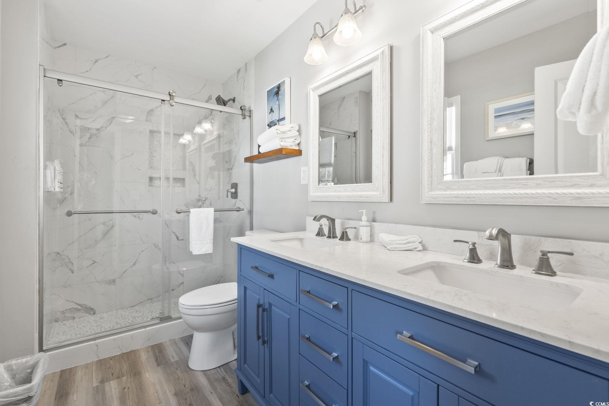 3182 State Rd S-26-816 Murrells Inlet, SC 29576 - Photo 13 of 40 Full bath featuring a marble finish shower, light wood finished floors, and double vanity