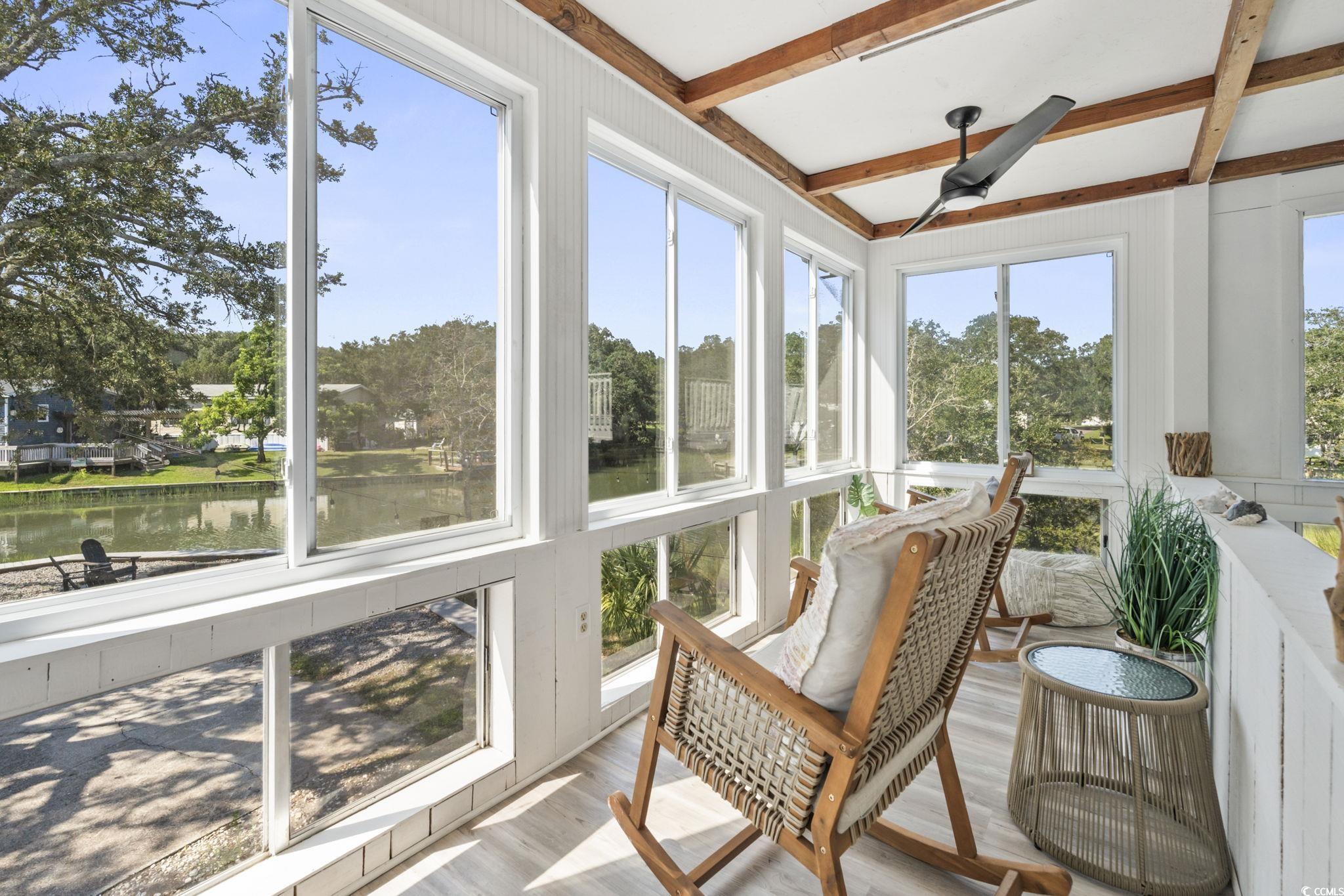 3182 State Rd S-26-816 Murrells Inlet, SC 29576 - Photo 2 of 40 Sunroom / solarium with beam ceiling, a water view, and a ceiling fan