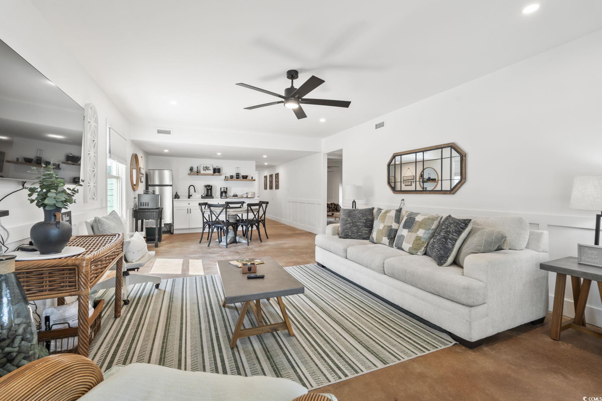 3182 State Rd S-26-816 Murrells Inlet, SC 29576 - Photo 21 of 40 Living area with a ceiling fan, recessed lighting, wainscoting, and finished concrete flooring