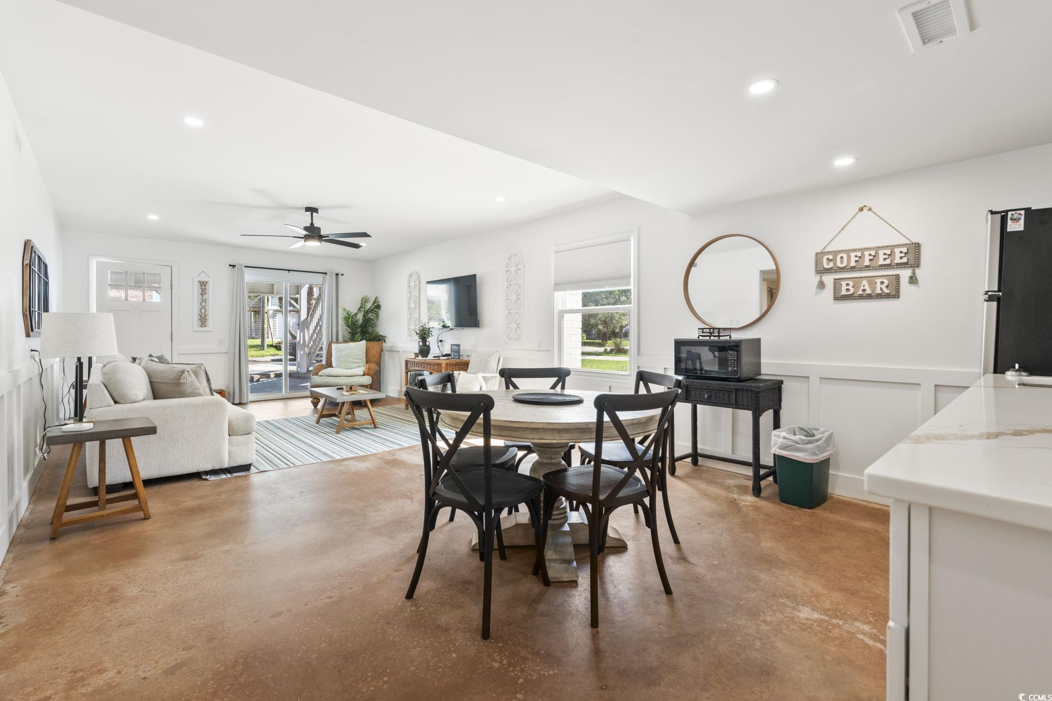 3182 State Rd S-26-816 Murrells Inlet, SC 29576 - Photo 24 of 40 Dining room featuring a wainscoted wall, a decorative wall, recessed lighting, finished concrete floors, and a ceiling fan