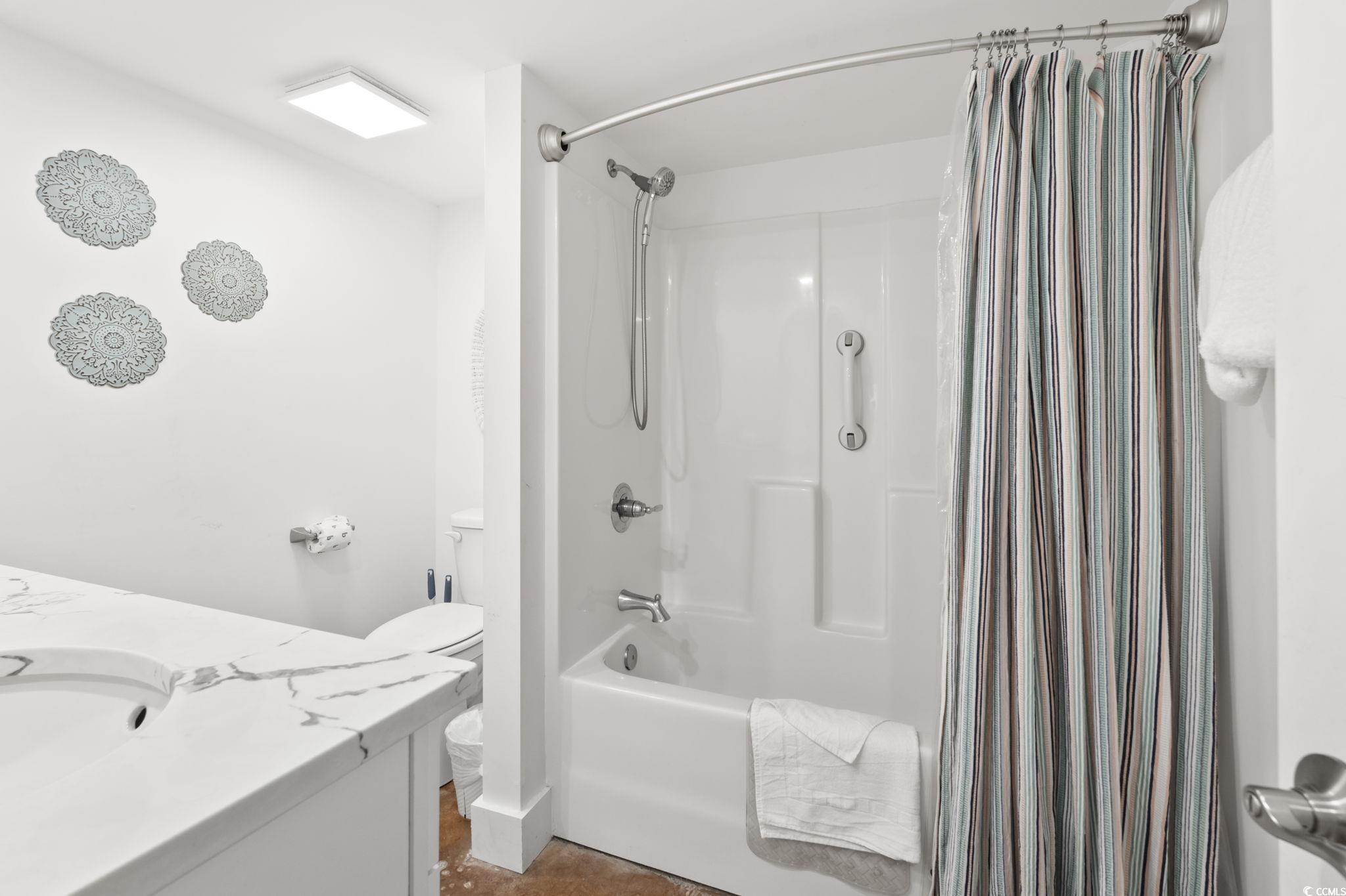 3182 State Rd S-26-816 Murrells Inlet, SC 29576 - Photo 28 of 40 Bathroom featuring shower / bathtub combination with curtain and vanity