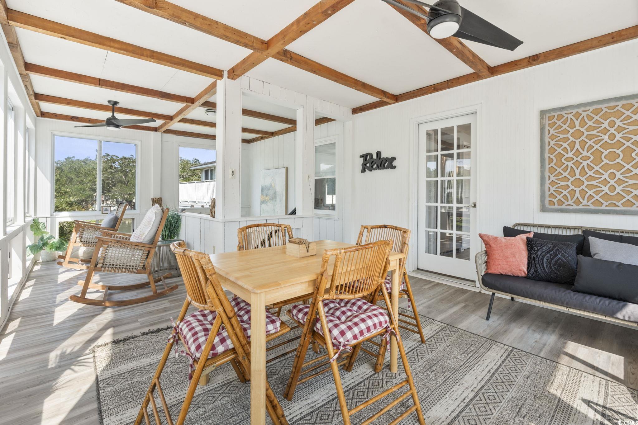 3182 State Rd S-26-816 Murrells Inlet, SC 29576 - Photo 32 of 40 Sunroom with a ceiling fan, beam ceiling, and outdoor dining area