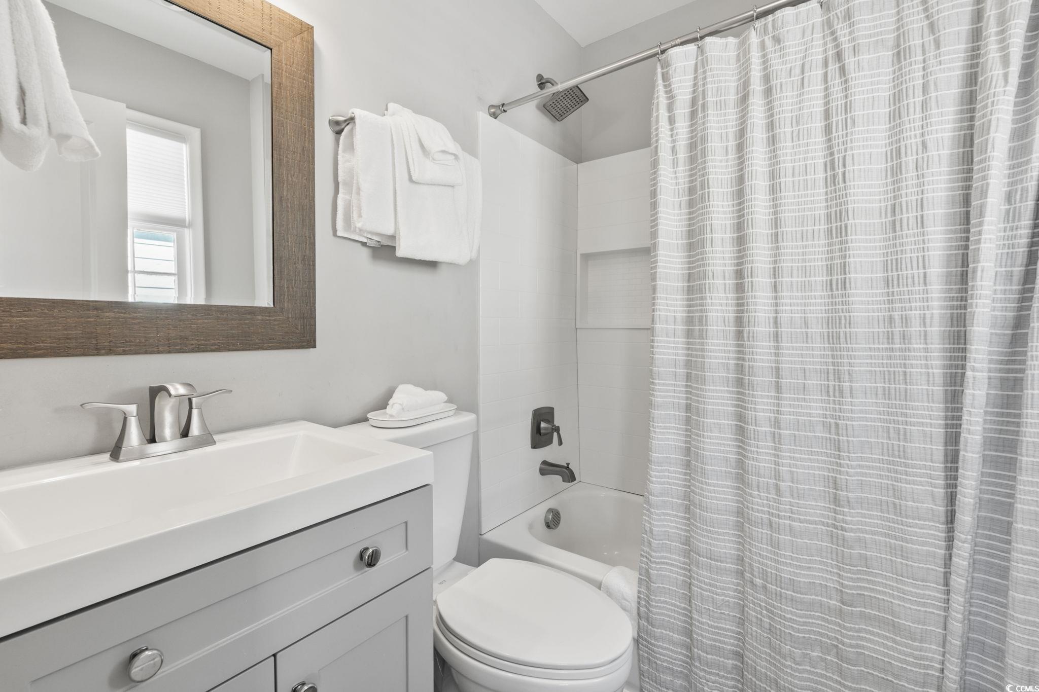 3182 State Rd S-26-816 Murrells Inlet, SC 29576 - Photo 33 of 40 Full bathroom with vanity and shower / bath combo with shower curtain