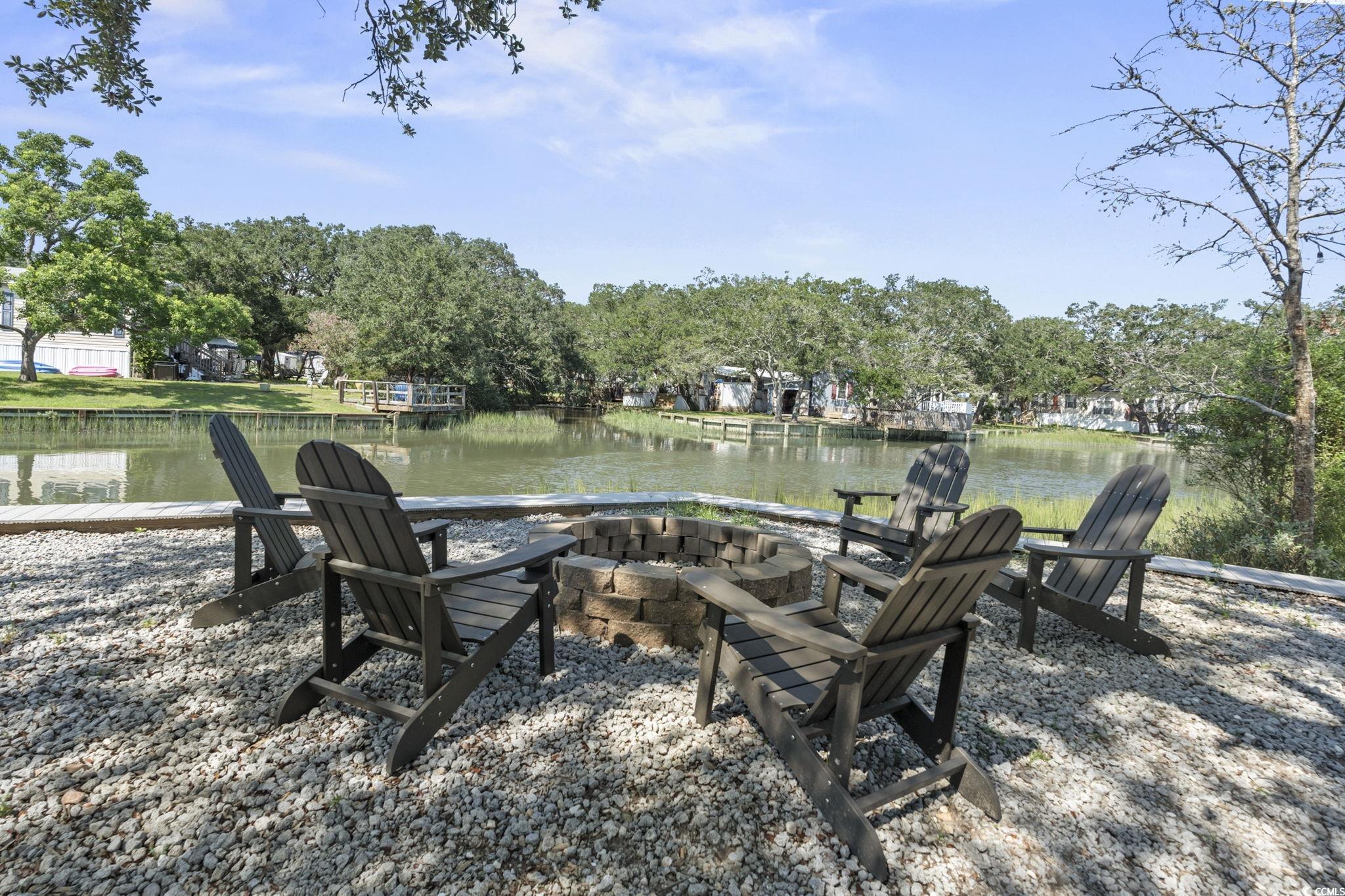 3182 State Rd S-26-816 Murrells Inlet, SC 29576 - Photo 36 of 40 View of yard featuring an outdoor fire pit and a water view