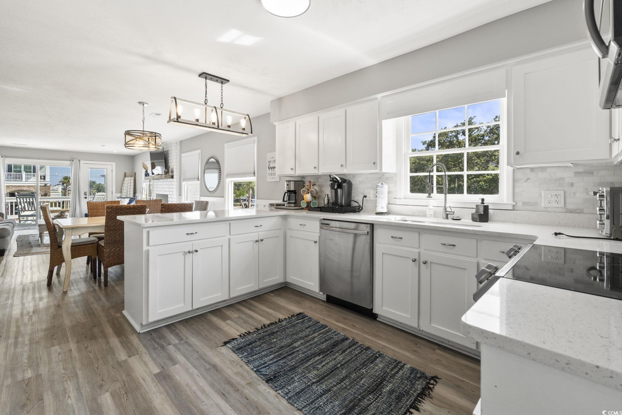 3182 State Rd S-26-816 Murrells Inlet, SC 29576 - Photo 40 of 40 Kitchen featuring white cabinets, open floor plan, light stone counters, and decorative backsplash