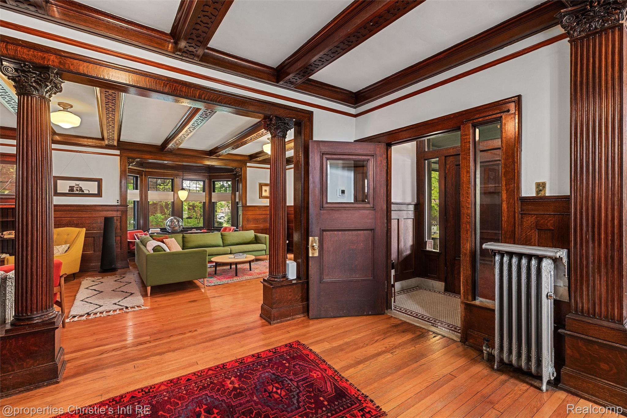 36 Longfellow Street Detroit, MI 48202 - Photo 14 of 81 Entrance foyer with decorative columns, a wainscoted wall, crown molding, light wood-style flooring, and beamed ceiling