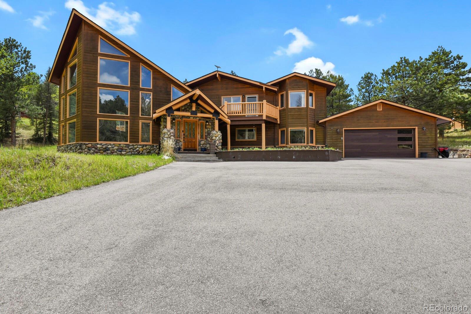 417 Witter Gulch Road Evergreen, CO 80439 - Photo 2 of 50 front view of a house with a yard