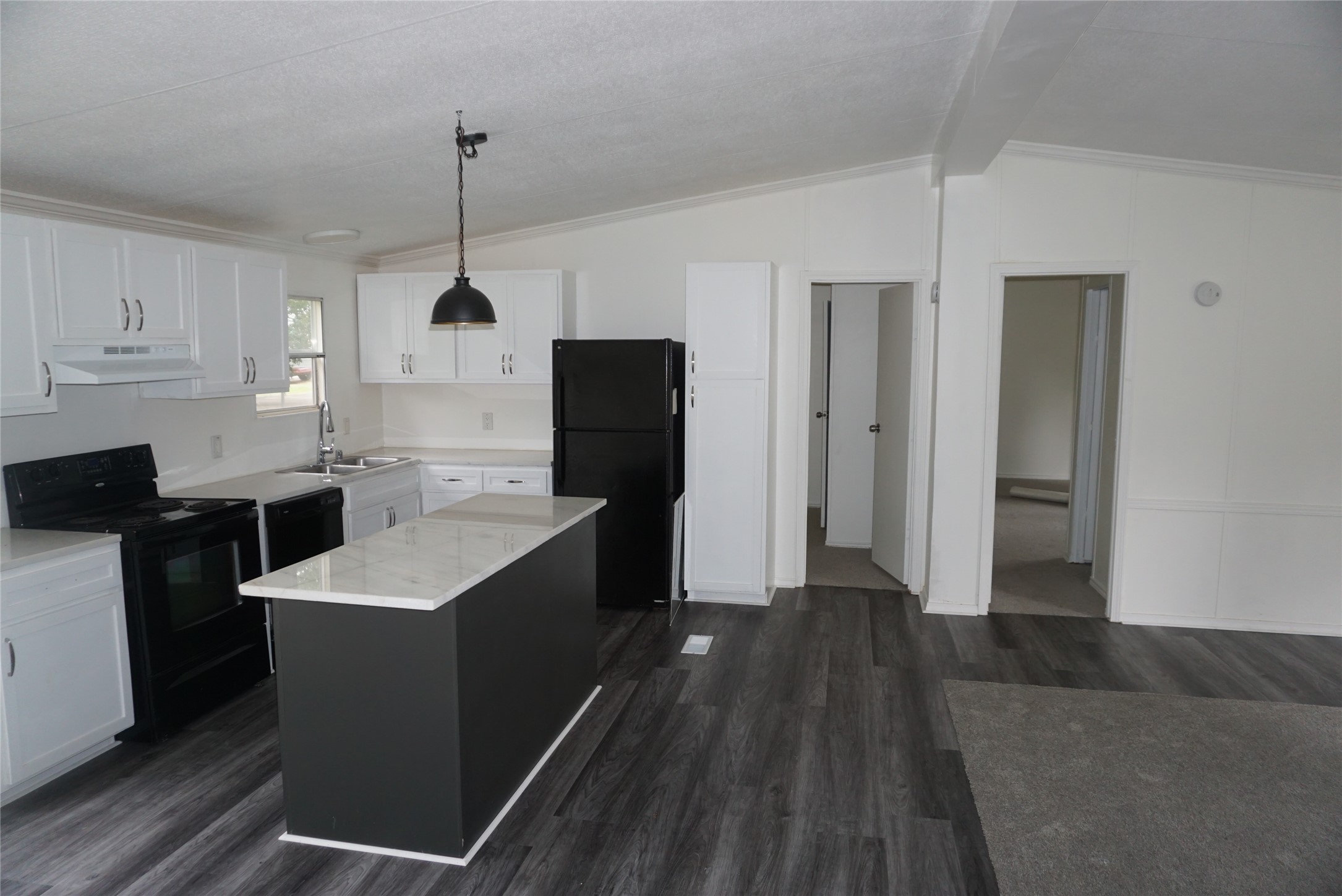 9603 Cedar Ridge Court Willis, TX 77318 - Photo 22 of 25 a kitchen with kitchen island a sink appliances and cabinets
