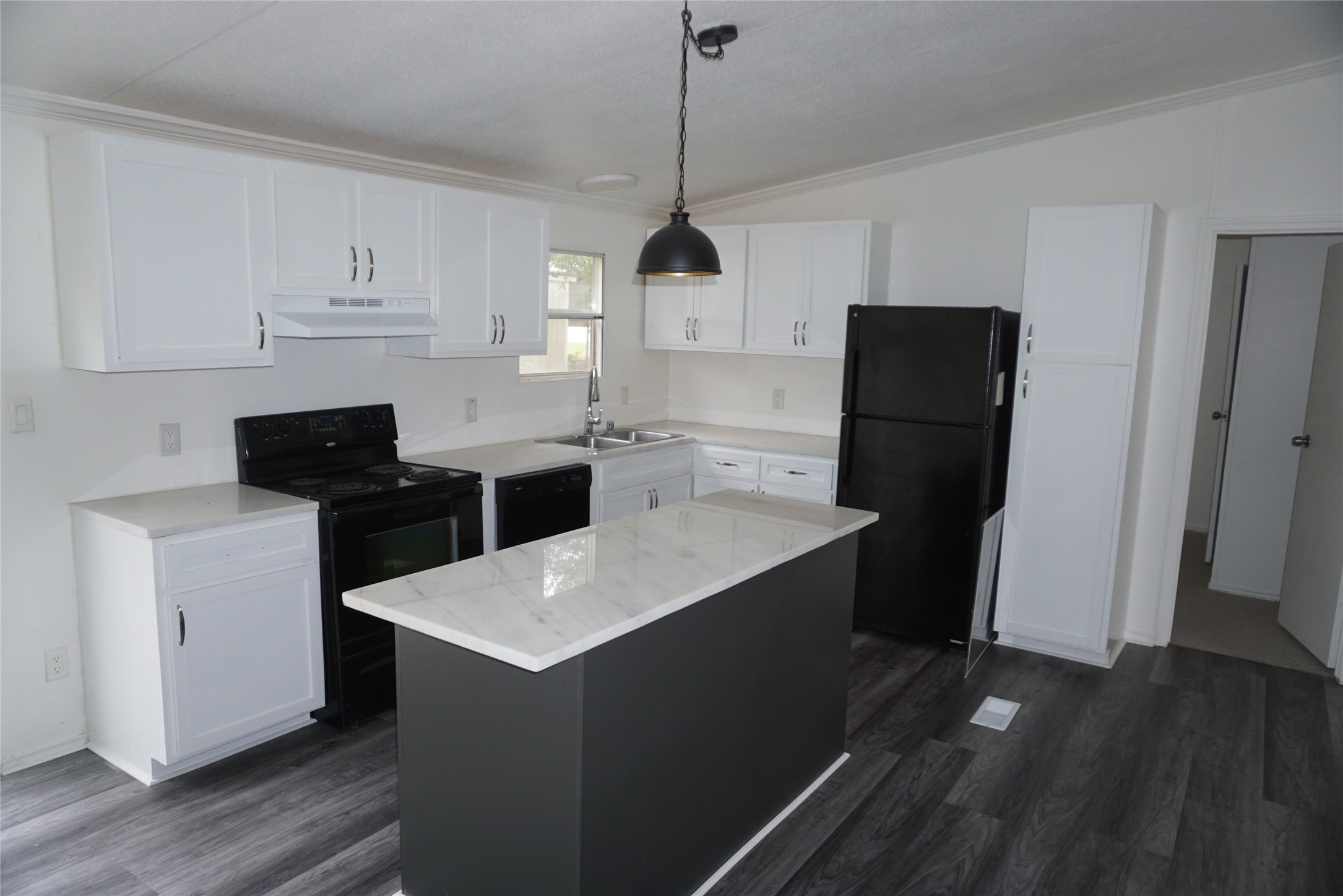 9603 Cedar Ridge Court Willis, TX 77318 - Photo 24 of 25 a kitchen with stainless steel appliances a stove a refrigerator a sink dishwasher and a stove with wooden floor