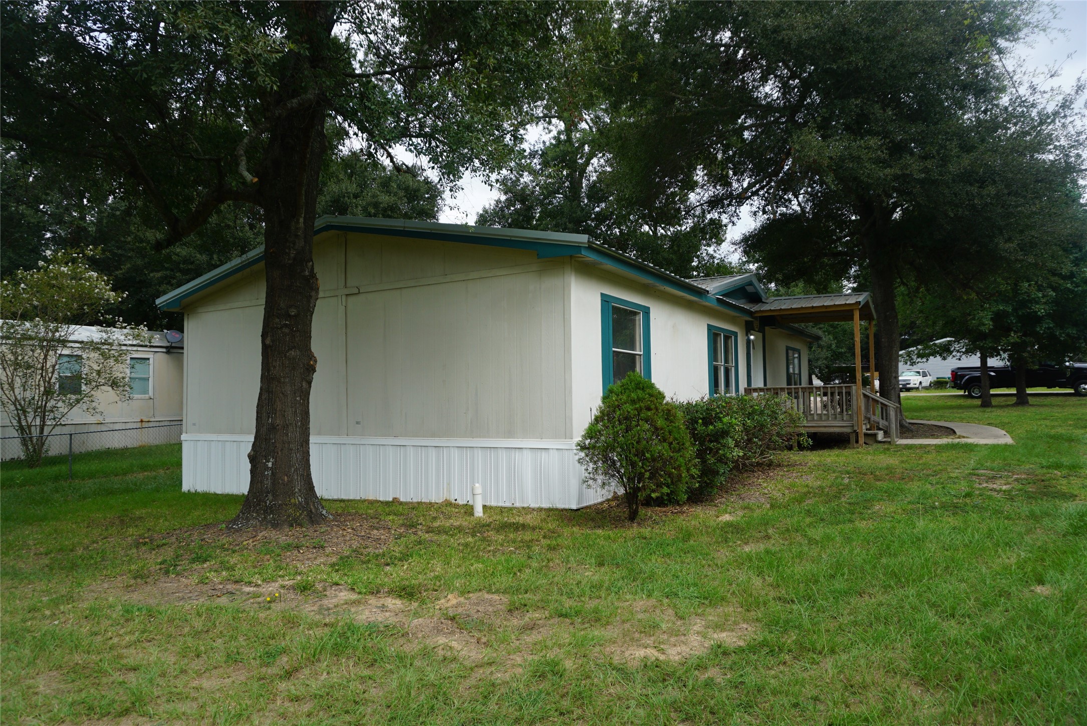 9603 Cedar Ridge Court Willis, TX 77318 - Photo 3 of 25 a backyard of a house with plants and large tree