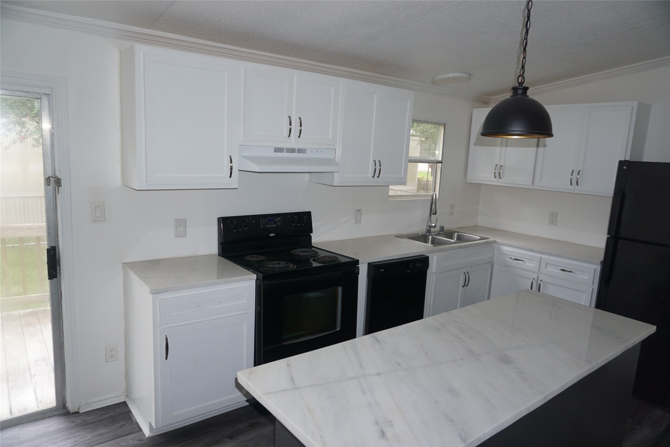 9603 Cedar Ridge Court Willis, TX 77318 - Photo 6 of 25 a kitchen with a sink a stove and refrigerator