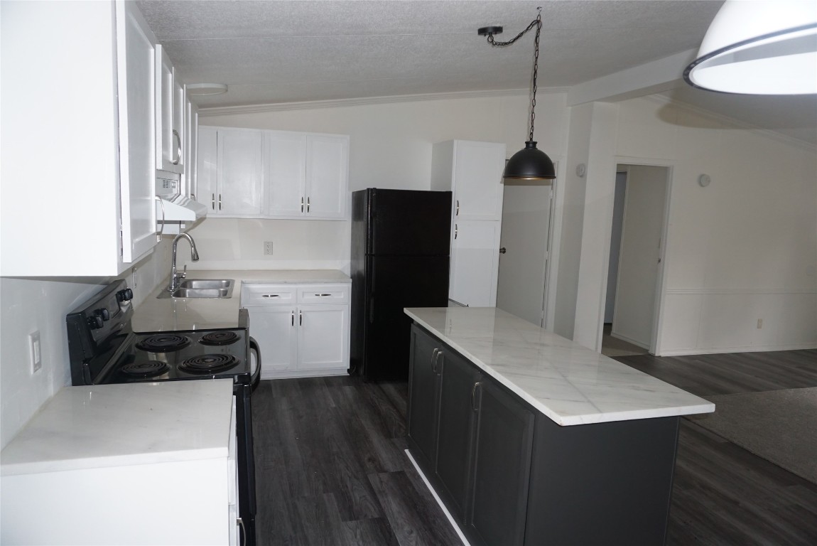 9603 Cedar Ridge Court Willis, TX 77318 - Photo 7 of 25 a kitchen with a sink a refrigerator and wooden floor
