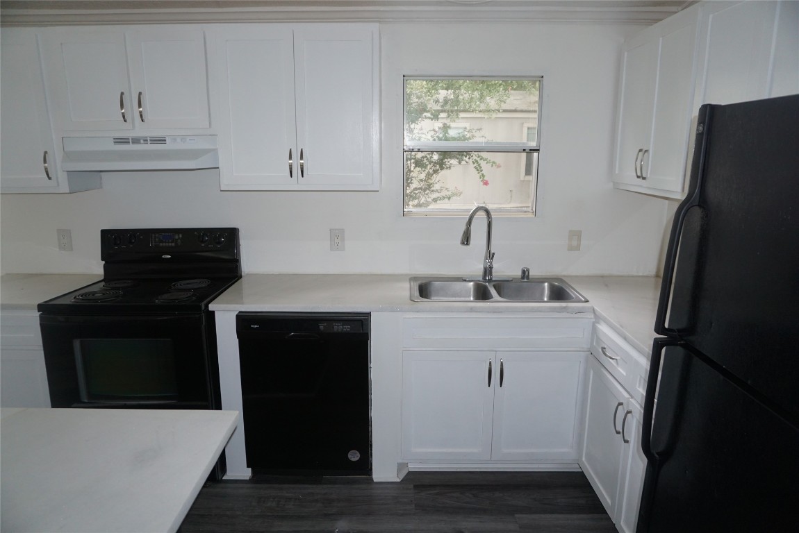 9603 Cedar Ridge Court Willis, TX 77318 - Photo 8 of 25 a kitchen with a sink and a refrigerator
