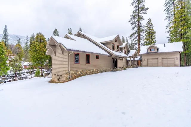 a living room with furniture a fireplace and a floor to ceiling window