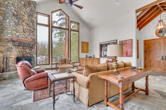 a living room with furniture a large window and a table