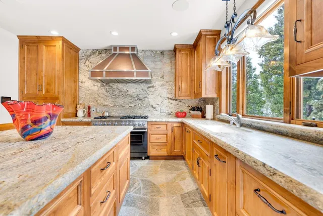 a bedroom with a bed and a large window with outer view