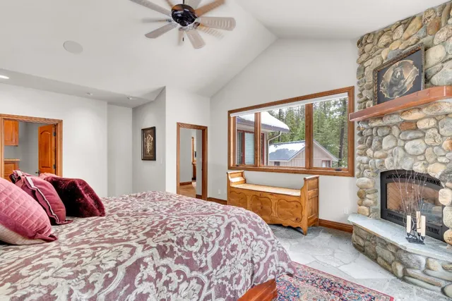 a utility room with stainless steel appliances granite countertop cabinets and a refrigerator