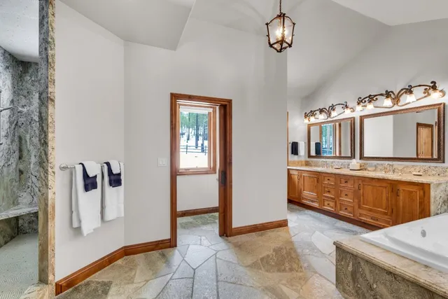 a view of a livingroom with wooden furniture and windows