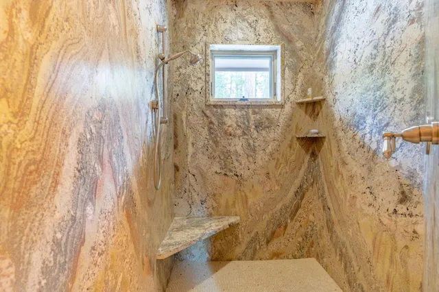 a balcony with furniture and a large window