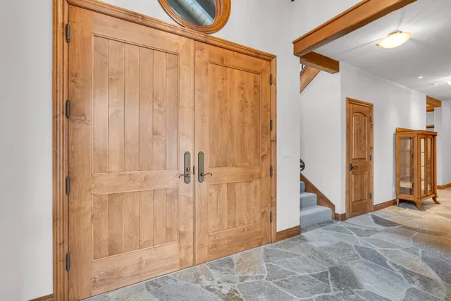 a bed sitting in a spacious bedroom next to a window