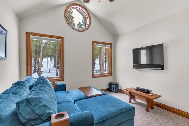 a living room with furniture and large windows