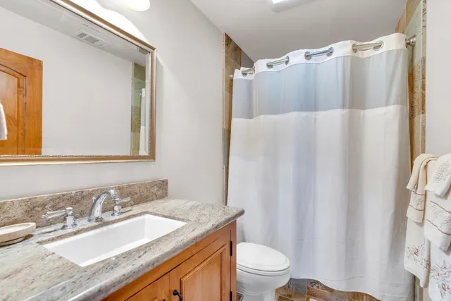 a front view of a house with yard and sitting area