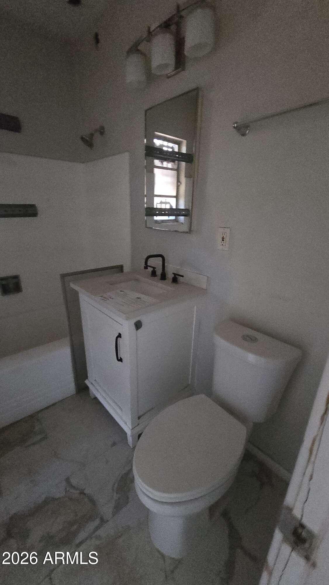 834 West Osborn Road Phoenix, AZ 85013 - Photo 12 of 45 a bathroom with a toilet sink and mirror