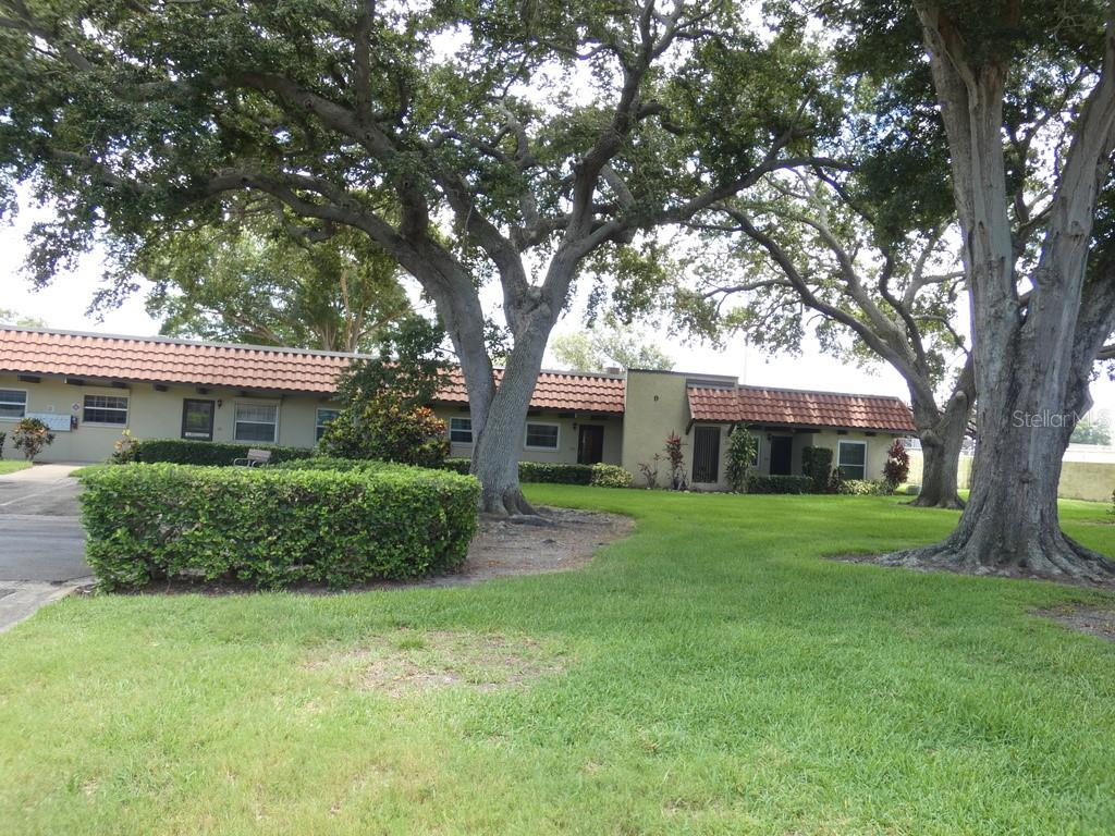 1701 Pinehurst Road, Unit 9G Dunedin, FL 34698 - Photo 22 of 22 a front view of a house with a garden
