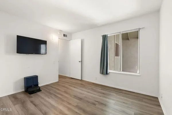 a view of a storage room with furniture and a window