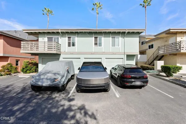 an aerial view of a house with a garden and lake view