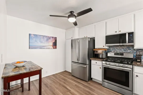 a kitchen with stainless steel appliances a stove a sink and a refrigerator