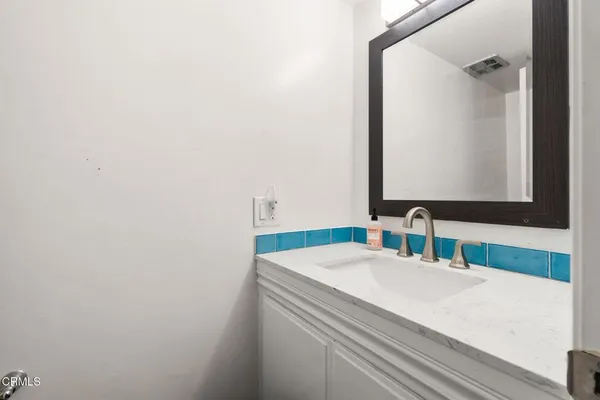 a bedroom with a bed and a flat tv screen on dresser