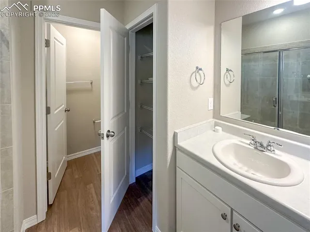 a bathroom with a glass shower door