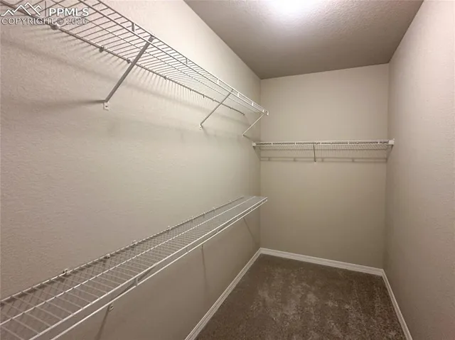 an entryway of a house with wooden floor and stairs