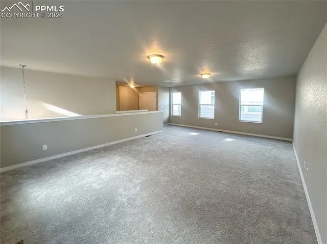 an empty room with windows and closet